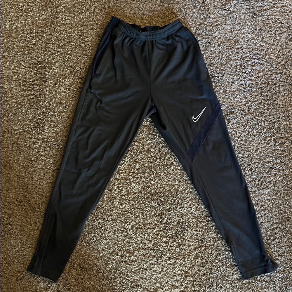 Nike Black Dri-Fit Track Pants.Item has a small flaw in the material on one leg.